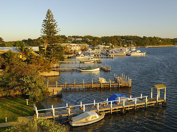 Boats moored at jetty in Metung